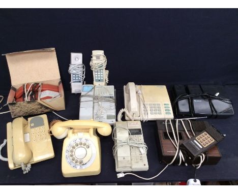 A collection of vintage late 20th Century telephones and cameras
