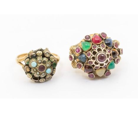 A stone set Indian style 9ct gold ring, comprising a domed setting probably silver, set with garnet, ruby, agates, tigers eye