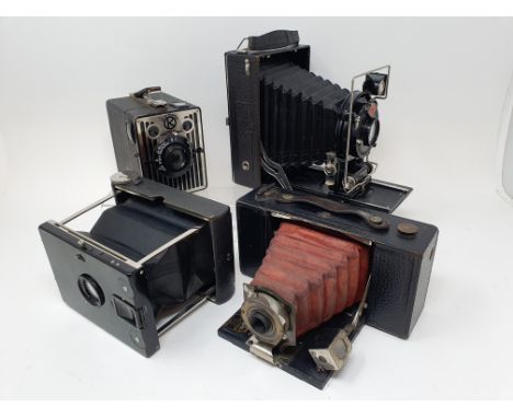 A C. P. Goerz Tenax folding camera, an Agfa folding camera, a Kodak 2 folding pocket brownie camera, a Kodak Six-20 brownie b