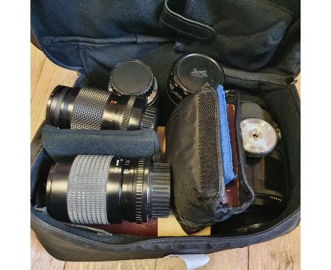 A Pentacon camera les and six other camera lenses and a camera bagProvenance: Part of a vast single owner collection of camer