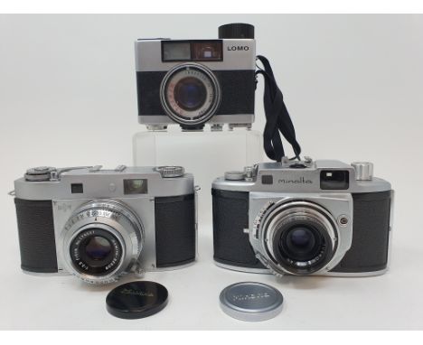 A Mamiya-35 camera, with outer leather case, a Lomo 35 BC camera, and a Minolta A camera, with outer leather case, with a lig