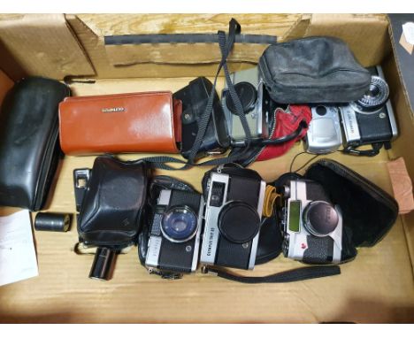 An Olympus Trip 35 camera, an Olympus I-10 camera, an Olympus-Pen camera, an Minox 35 GT camera, an Olympus A11 camera, an Ol