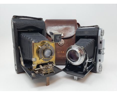 A Zeiss Ikon Ikonta folding camera, in leather outer case, and a Kodak model H folding camera, in leather outer case (2)Prove