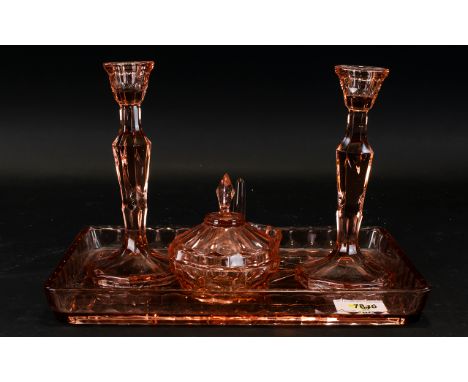 A Pink Coloured Glass Dressing Table set comprising tray, candlesticks, trinket dish and jewelry holder,