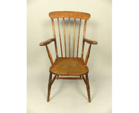 19th Century Windsor chair comb back, elm arms and saddle seat, ring turned legs. 