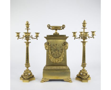 French 19th century Empire style clock set, gilt bronze decorated with rams' heads, floral garlands and amphora, flanked by t