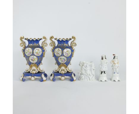 Pair of porcelain vases 19th century with rocaille motifs and medallions of flowers and birds on a blue ground, with curly ha