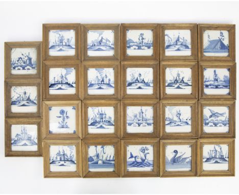 A collection of 23 Delft blue tiles, 19th century, mounted in wooden frames and depicting landscapes, animals, mills, figures