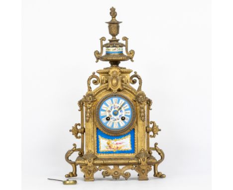 A richly decorated and gilded mantle clock in Louis XVI style, enamel dial with Roman numerals, decorated with enamel plaque 
