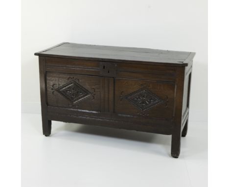 Rectangular oak chest on short straight legs, with carved front with two Gothic inspired diamond fields with floral motifs, 1