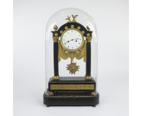 French column clock made of polished black onyx with gilt bronze decoration under a glass dome, surmounted by two doves and a
