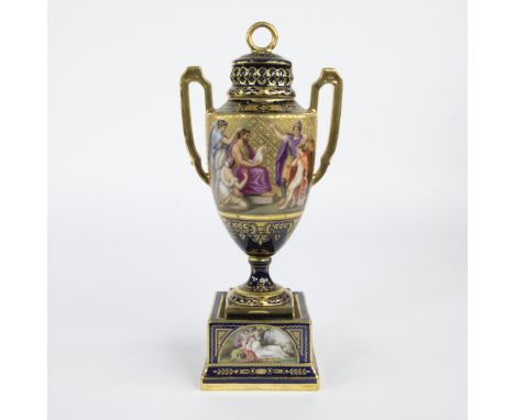 Finely hand-painted amphora in Empire style in cobalt blue porcelain with gilded details and handles and decorated with mytho
