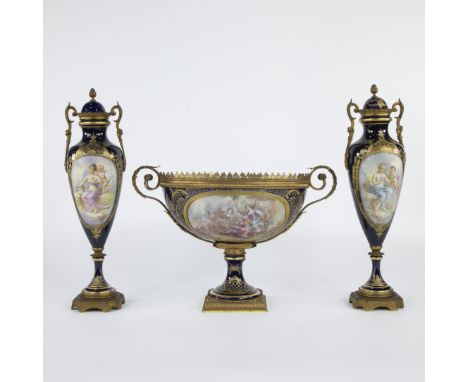 French three-part decorative garniture in Sèvres style, consisting of two amphora vases and a central coupe on a foot in deep