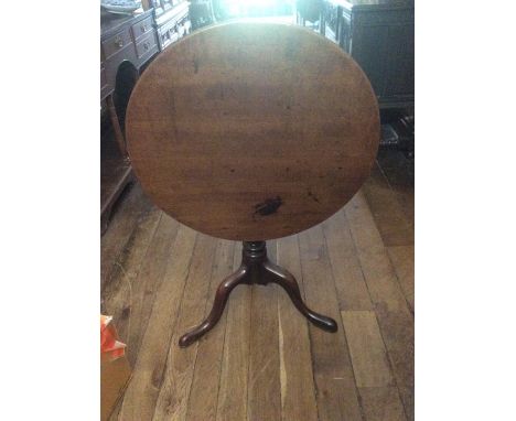 A George III mahogany tilt top tripod table, baluster turned column