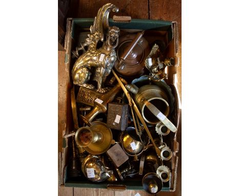 A box of assorted metal wares including cast brass winged lion, copper kettle, Estyma alarm clock, brass casket, brass chambe