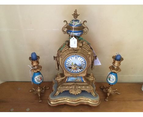 A late 19th century French gilt metal matched garniture clock set, comprising clock with eight day movement, hand painted ena