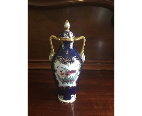 A Graingers  Worcester Royal China Works twin handled vase and cover. Scale blue ground with exotic birds within gilt cartouc