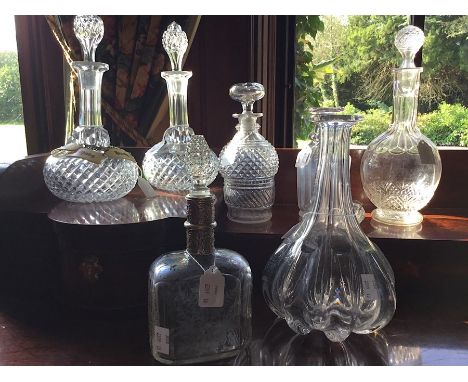 A pair of Victorian cut glass shaft and globe decanters, bulbous body with diamond cut, star cut base, Height to neck 19.5 cm