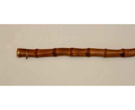 A bamboo walking stick, untested gold pommel and handle loop, pommel engraved with initials and bulls head, length 84.5 cms.