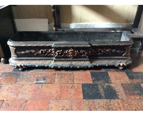 A 19th Century planter, of rectangular breakfront form, ebonised with gilt scrollwork in the 18th Century French style, lead 