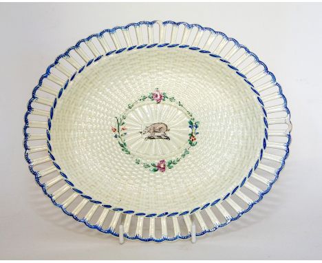 A Leeds creamware pottery oval dish with a pierced gallery rim and moulded basket weave body. Painted with blue borders. The 