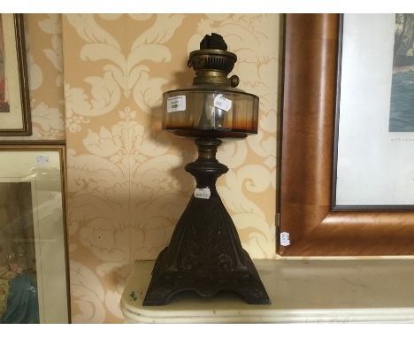 A cast iron based 19th century oil lamp