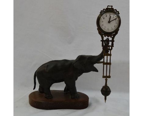 Spelter Elephant pendulum clock.&nbsp;Pendulum&nbsp;with enamel&nbsp;dial, floral and scroll decoration, all on plinth&nbsp;b