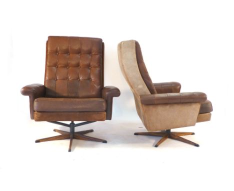 A pair of brown leather button upholstered and suede lounge armchairs on simulated rosewood five star swivel bases CONDITION 