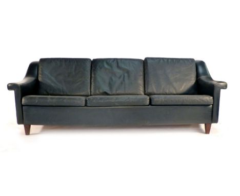 A 1970's black leather three seater sofa on mahogany tapering legs CONDITION REPORT: Some wear, particularly around arms, gen