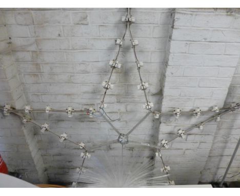 An aluminium fairground-type light in the form of a star CONDITION REPORT: Sold as a collectors item, may require entirely re