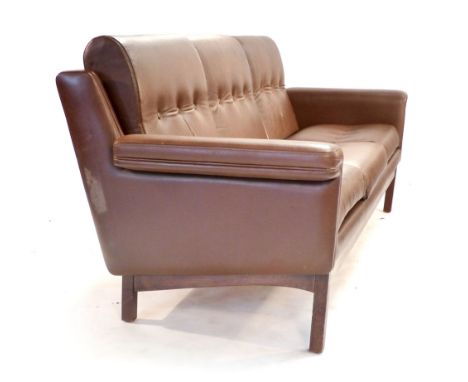 A 1970's brown and button upholstered three seater sofa on an oak frame CONDITION REPORT: Some minor wear, generally good for