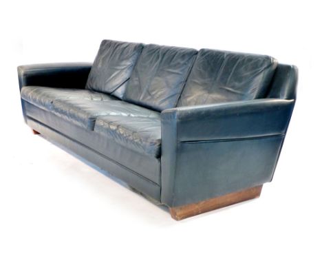 A black leather three seater sofa on a pair of plinth type supports CONDITION REPORT: no obvious rips to upholstery noraml we