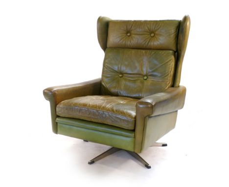 A Skippers Mobler green leather and button upholstered wingback armchair on a chromed five star swivel base  CONDITION REPORT