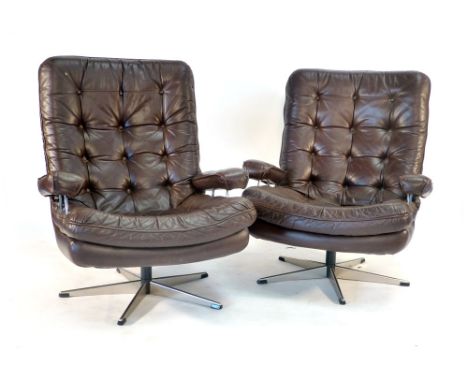 A pair of 1970's brown leather and button upholstered armchairs with chromed frames on five star swivel bases CONDITION REPOR