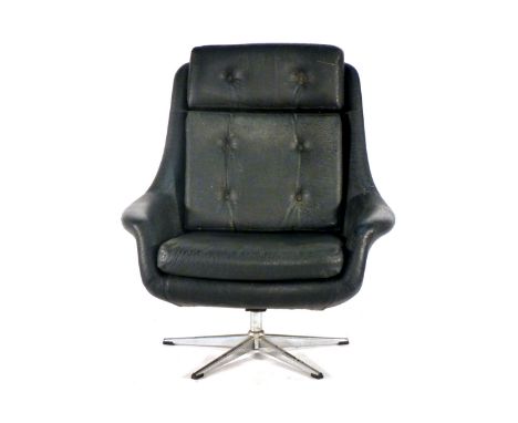 A 1970's black vinyl and button upholstered lounge armchair on a four star swivel base
