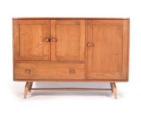 An Ercol elm and beech sideboard with an arrangement of three doors one drawers on tapering legs. w. 114 cm CONDITION REPORT: