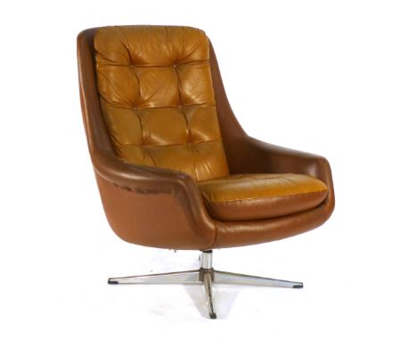 A 1970's tan vinyl and button upholstered lounge armchair on a four star swivel base CONDITION REPORT: tired, missing buttons