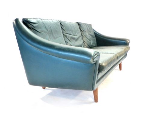 Aage Christiansen for Erhardsen and Andersen (Eran), a 1970's green leather three seater sofa on teak tapering legs CONDITION