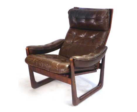 A 1970's stained beech and brown button upholstered adjustable reclining armchair on a sleigh-type base CONDITION REPORT: hea