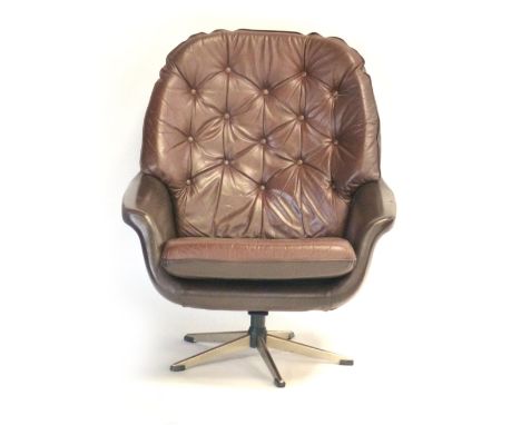 A 1970's brown and button upholstered tub style chair on a five star swivel base CONDITION REPORT: some discolouration and mi