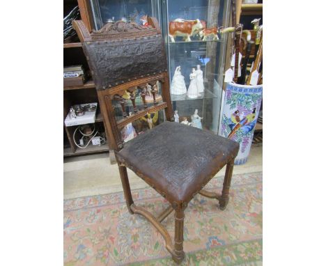 A vintage chair with embossed leather detail