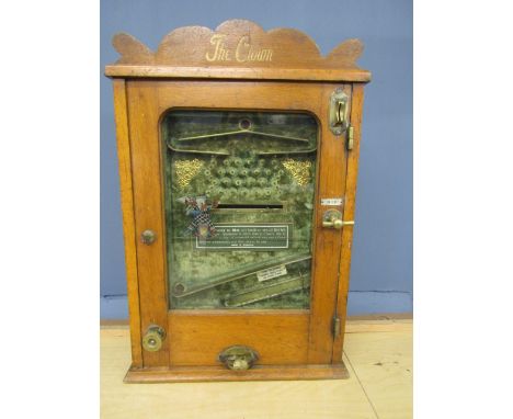 'The Clown' an early 20th century penny in the slot arcade machine, in an oak case, together with a quantity of tokens with P