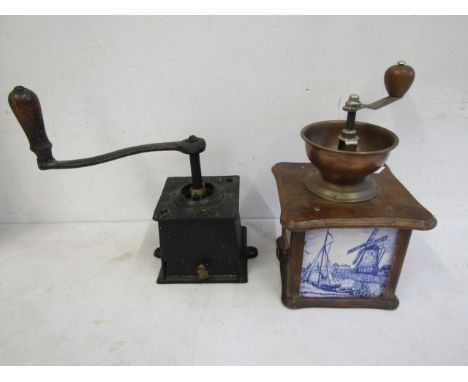 2 vintage coffee grinders, one cast iron and the other ceramic delft pattern with copper mill