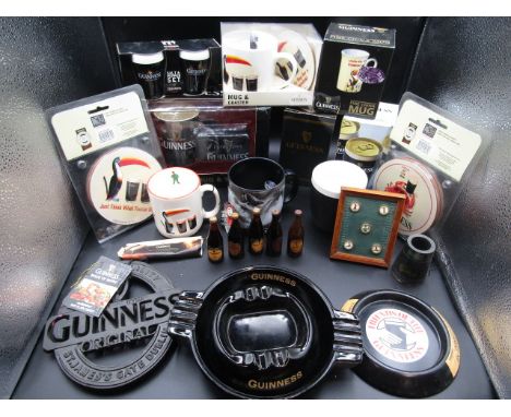 Guinness collectables inc mugs (some new and boxed) miniature bottles, button presses, cast iron trivet, coasters, ashtrays e