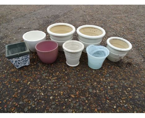 7 Ceramic garden pots and one glass pot. Largest H19cm approx