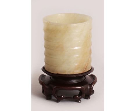 A GOOD 17TH CENTURY CHINESE BAMBOO FORM CELADON GREEN JADE BRUSH POT, with a wood base and carved fitted stand, the stone wit