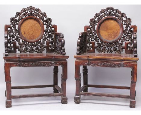 A GOOD PAIR OF 19TH CENTURY CHINESE HARDWOOD CHAIRS, each well carved in pierced relief with swirling cloud scrolls, each bac