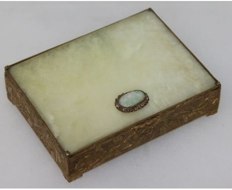 AN EARLY 20TH CENTURY CHINESE CELADON GREEN BOWENITE & GILT METAL RECTANGULAR BOX, the hinged cover with an inset plain bowen