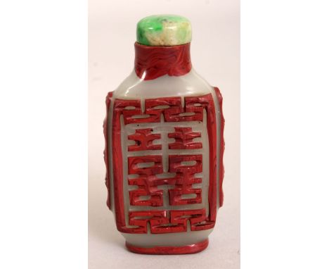 A CHINESE RED OVERLAY SNUFF BOTTLE & APPLE GREEN JADE STOPPER, decorated on each side over an opaque ground with an auspiciou