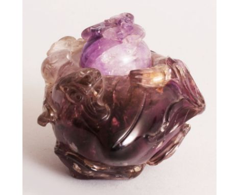 A 19TH CENTURY CHINESE AMETHYST PEACH-FORM CENSER & COVER, the sides carved in high relief with leafy tendrils, the cover car